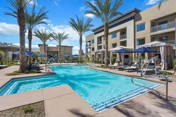 Resort-style swimming pool and spa with cabanas